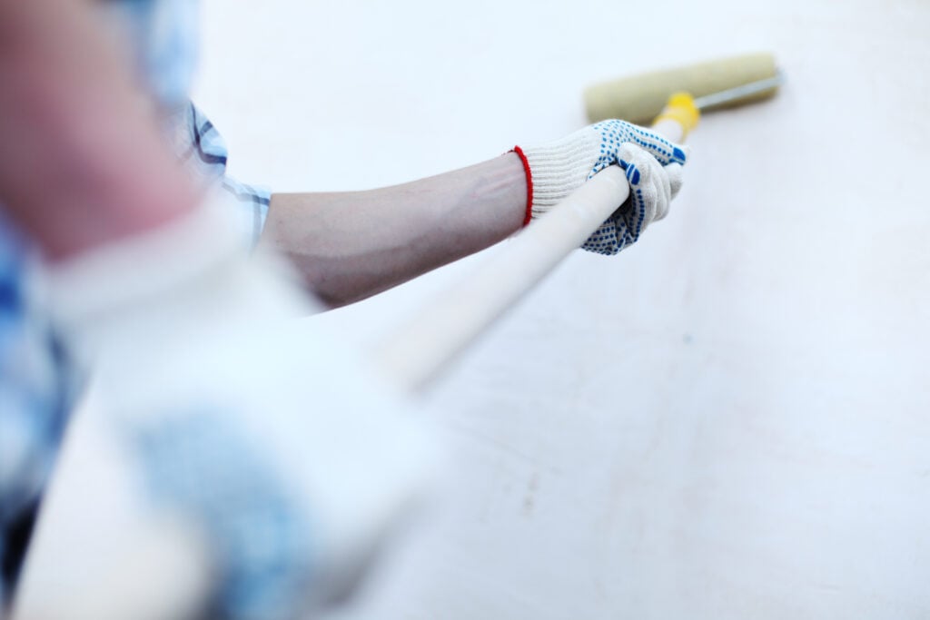 painter rolling an interior wall